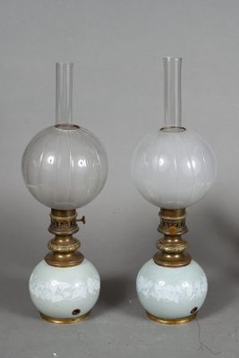 three white glass lamps sitting on top of a table next to each other