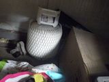 a toilet in the corner of a room with a lot of stuff on the floor