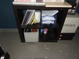 a book shelf with books on it in a room