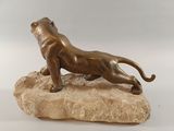 statue of a lion on a rock on a white background