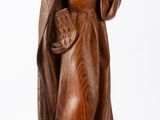 wooden statue of a woman holding a flower in her hand