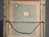 an image of a painting on a wooden easel with a piece of paper in it