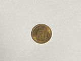 a close up of a gold coin on a white surface