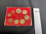 a close up of a red case with coins in it