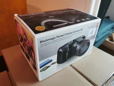 a black camera sitting on top of a box on a table