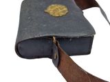an old book with a leather cover and a leather strap
