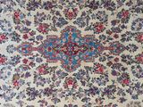 a close up of a rug with a floral design on it