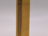 a gold lighter sitting on top of a white surface