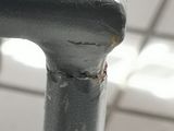 a close up of a metal pole with a white tile floor