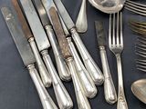 a lot of silver spoons and forks on the table