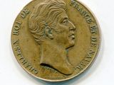 une pièce d'or sur laquelle figure le portrait d'une femme
