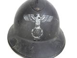 an old helmet with a bird on it is sitting on a table