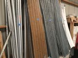 many different types of metal pipes and wires in a warehouse