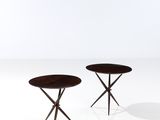a pair of round tables with wooden legs on a white surface