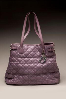 purple quilted tote bag with a lock on the handle