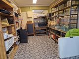 a room with a lot of shelves and a refrigerator in it