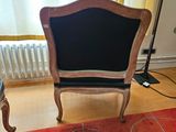 a chair and a table in a room with a red carpet
