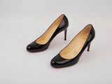 a pair of black high heels on a white surface