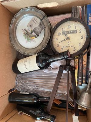 a box full of wine bottles and a clock in it