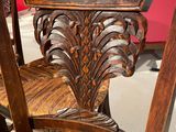 a wooden chair that has a wooden seat on it