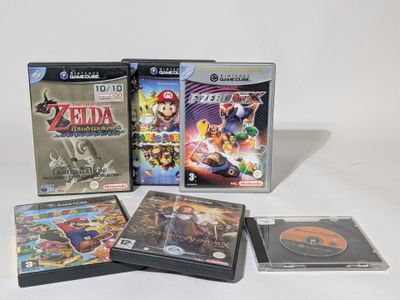 three video games on the table with a white background