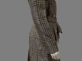 a mannequin dressed in a brown and white checkered coat and skirt