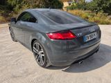 the rear end of a grey audi car parked in a parking lot