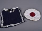 a white hat and a blue shirt on a table