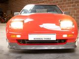 an image of a red sports car in a garage