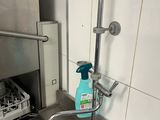 a kitchen sink with a bottle of cleaner on it