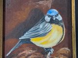 painting of a blue and yellow bird sitting on top of a pile of leaves