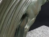 statue of a woman on a horse with a long flowing mane