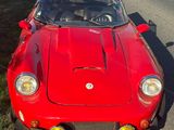 a red sports car parked on the side of the road