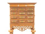 a small wooden chest of drawers on a stand