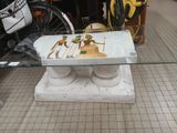 a table with a glass top that has a picture of a horse on it