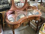 a vanity with a mirror on top of it in a room full of boxes