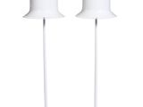 two white lamps sitting on top of each other next to each other