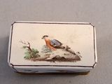 a small box with a painting of a bird on it
