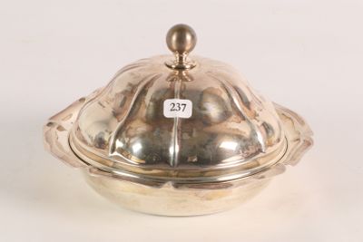 a silver bowl with a lid on a white surface