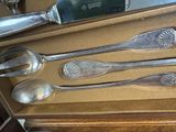 five silver spoons and a knife in a box