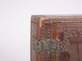 a small wooden box with a metal latch on it