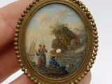 a miniature picture of a man and a woman on a boat