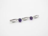 a pair of earrings with amethorate beads on a white background