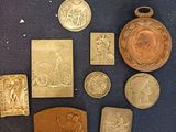 some of the gold medals are on display on a blue surface