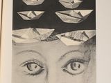 a black and white photo of a woman ' s face with paper boats in her head