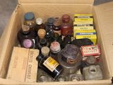 a cardboard box filled with bottles of alcohol and spices