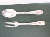 two spoons and a fork sitting on a table