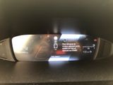 the dashboard of a car with a digital display on it
