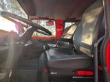 a red truck with black seats and a steering wheel