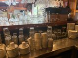 many cups and glasses on the counter in the store